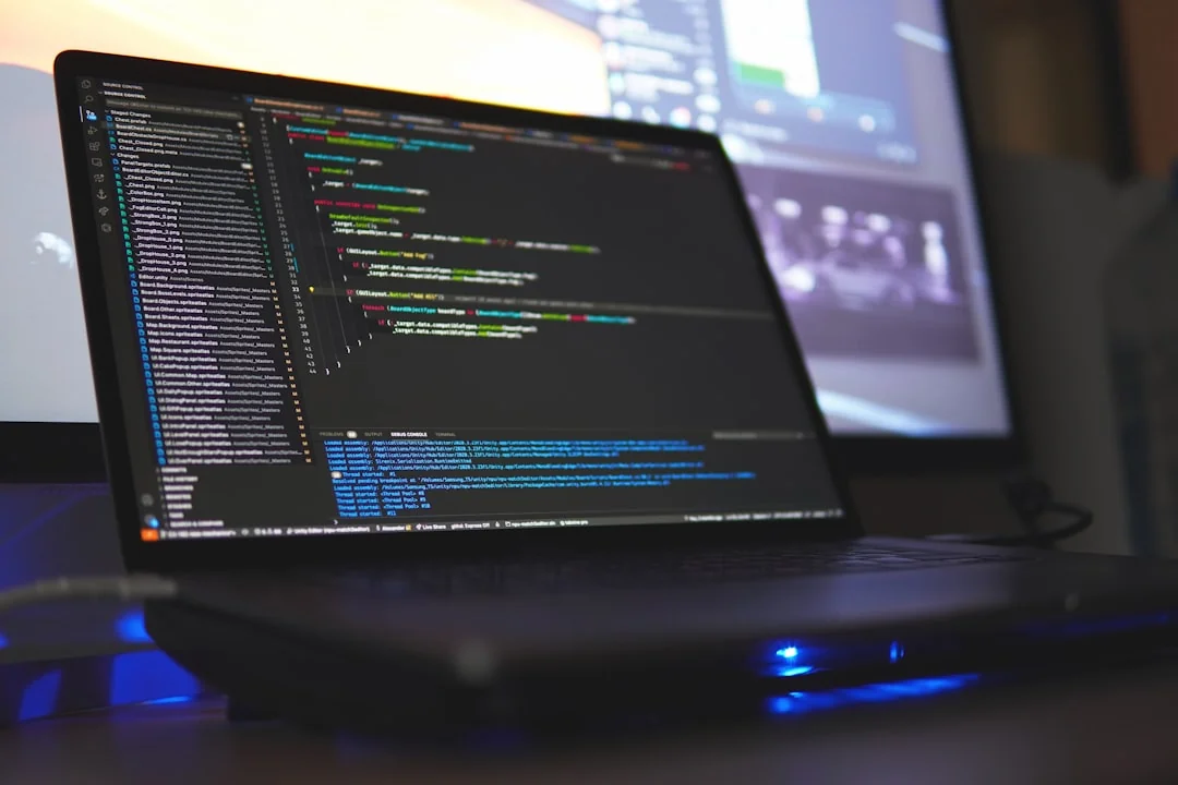 A modern workspace showing hands analyzing marketing data on a laptop and paper documents.